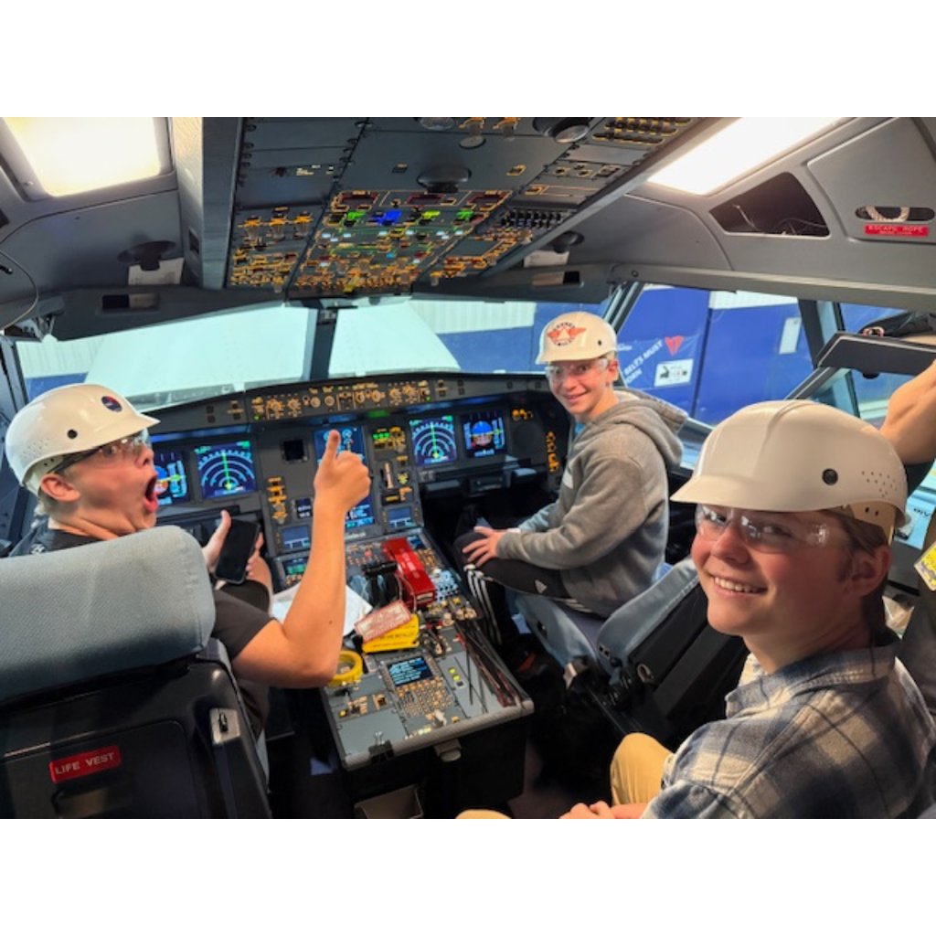 students sitting in the cockpit of an Airbus 330