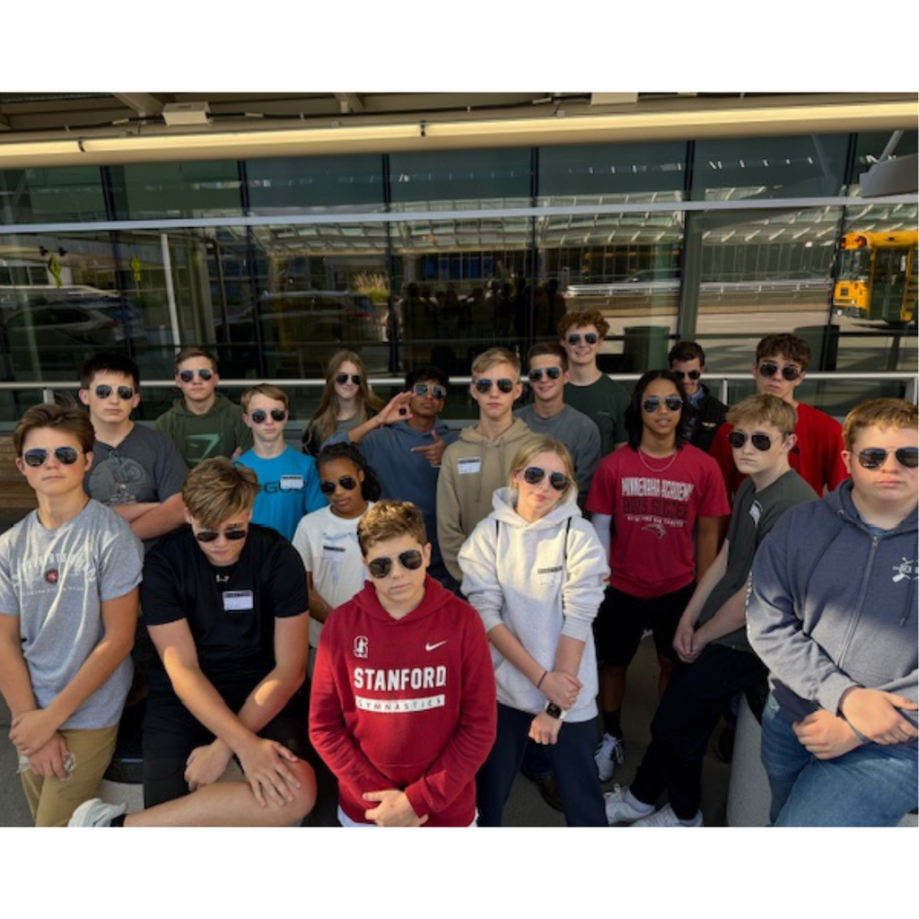 group photo of aviation students wearing aviator sunglasses