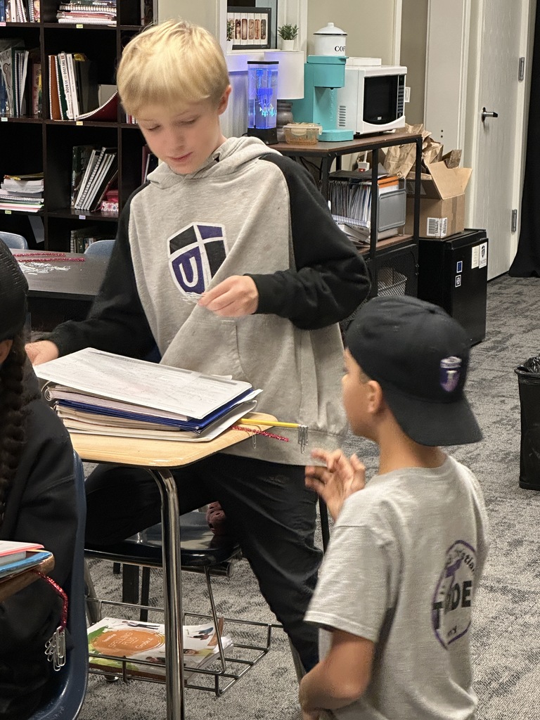 4th grade students working in pairs at their desks doing a science experiment
