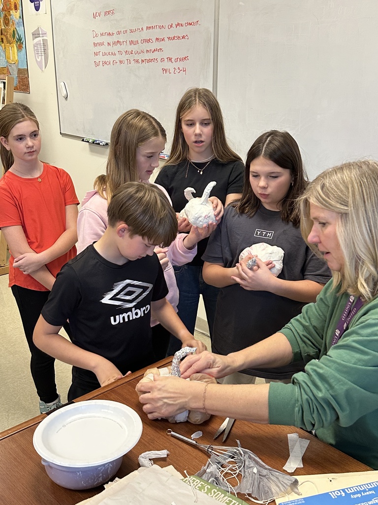 6th grade students making paper mache pumpkins in art class