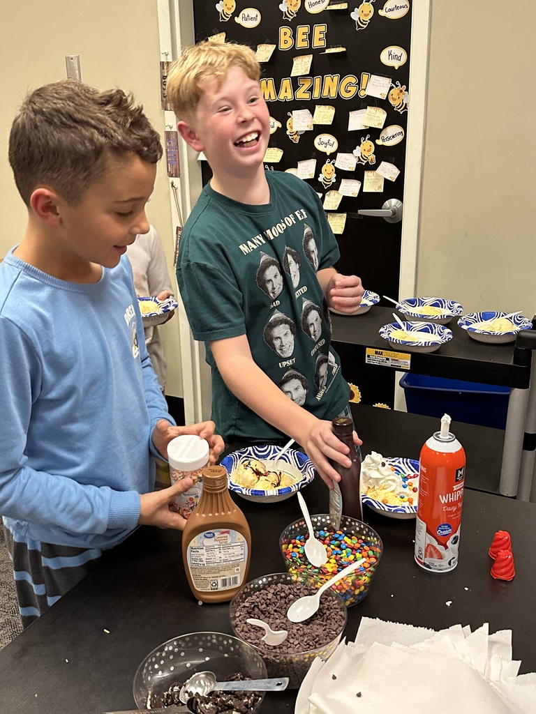 students scooping up ice cream toppings