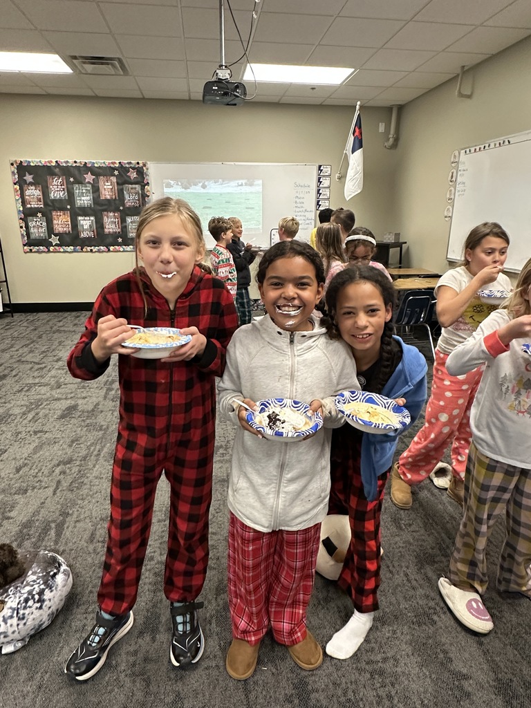 group of students wearing pajamas and eating ice cream