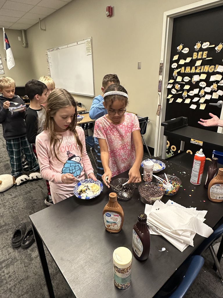 students scooping up ice cream toppings