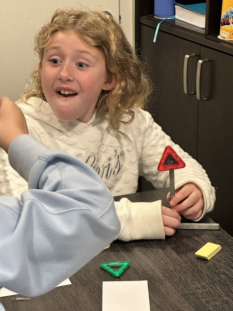 girl with excited look on her face as she discovers with magnets