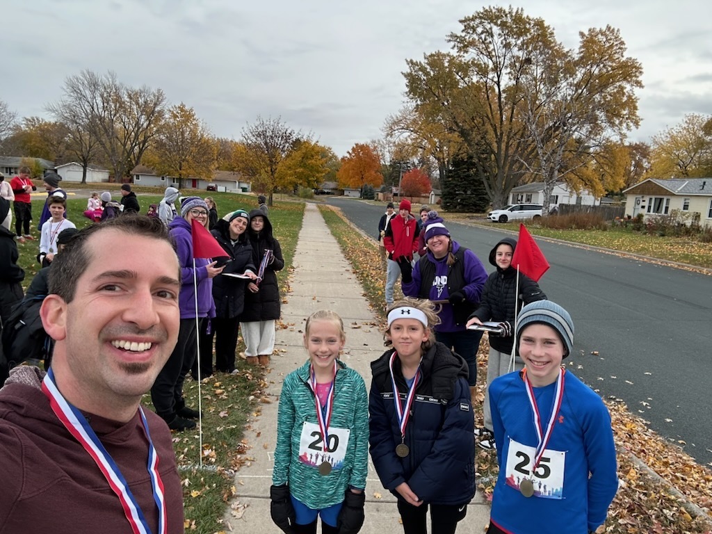 selfie of a family of runners at the finish line