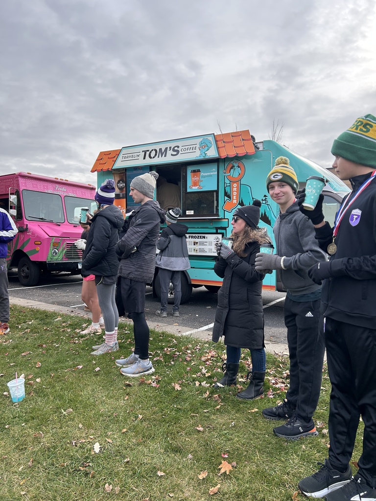 runners and spectators standing by food trucks