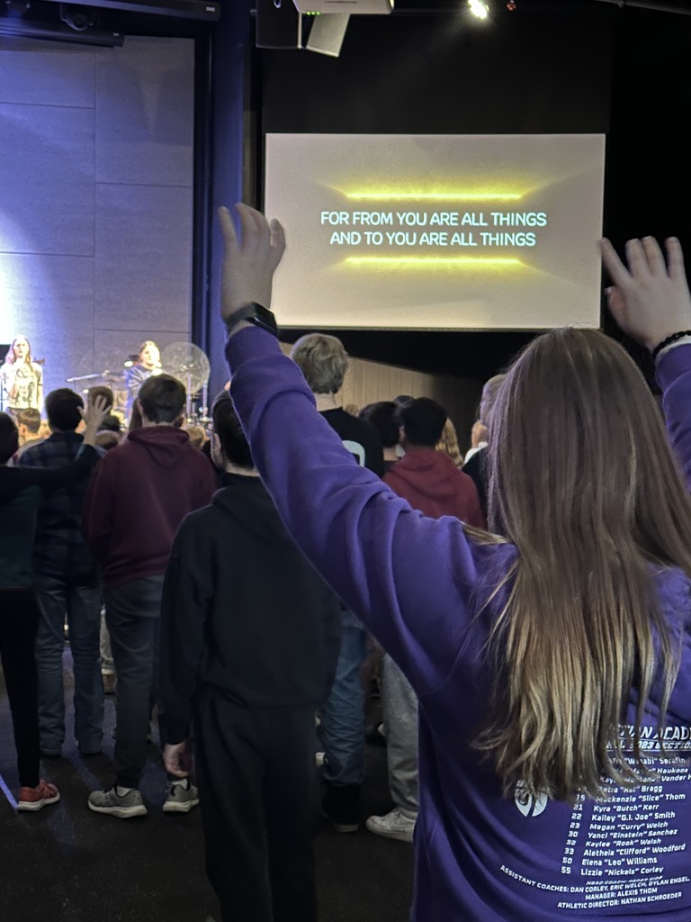 secondary students singing in a worship chapel service