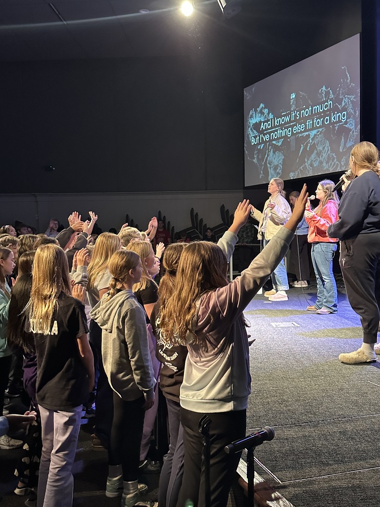 secondary students singing in a worship chapel service