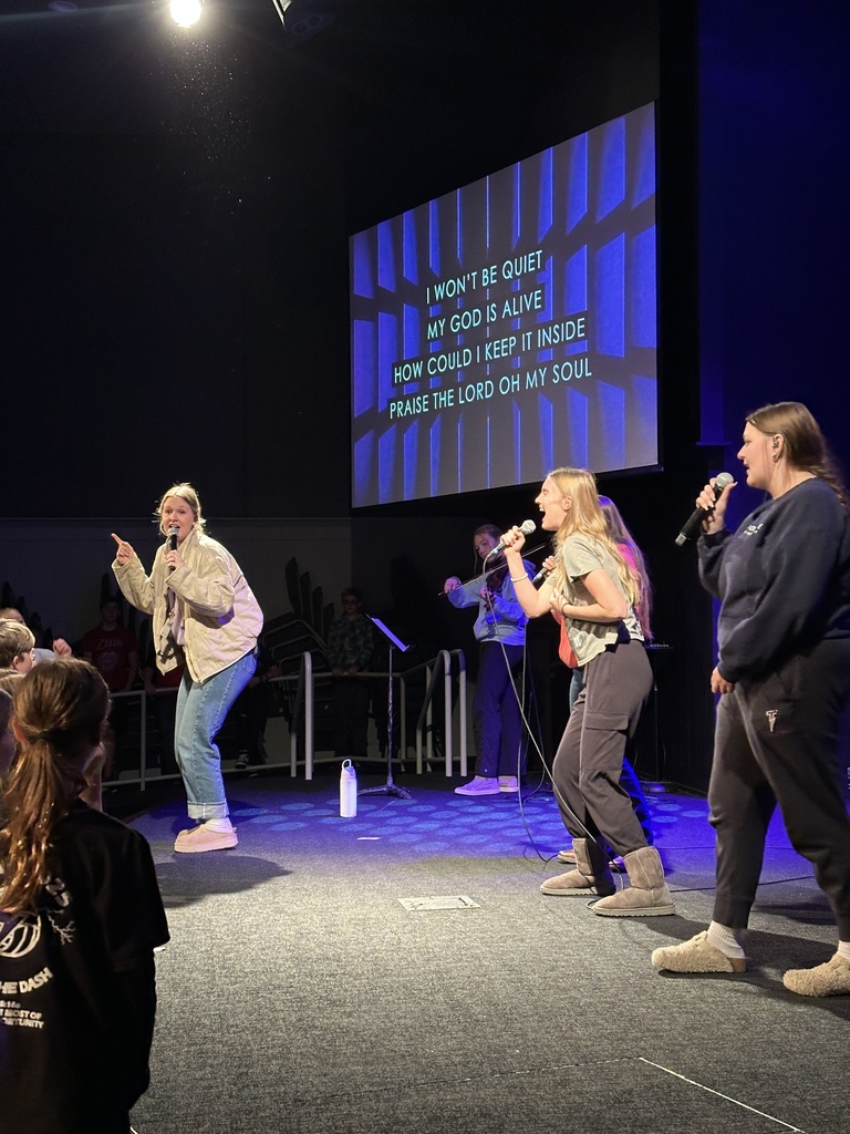 students leading worship from the stage
