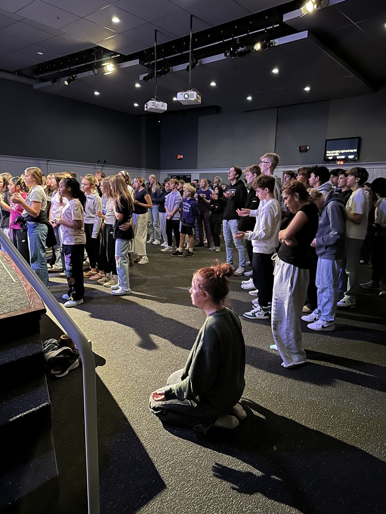 secondary students singing in a worship chapel service