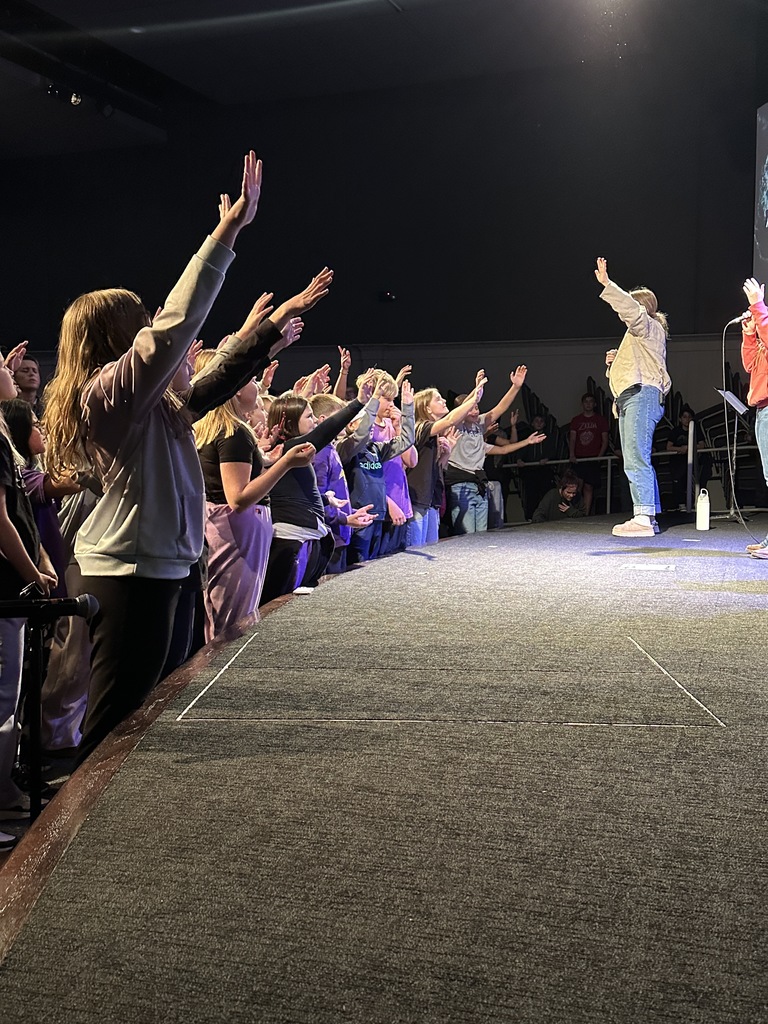 secondary students singing in a worship chapel service