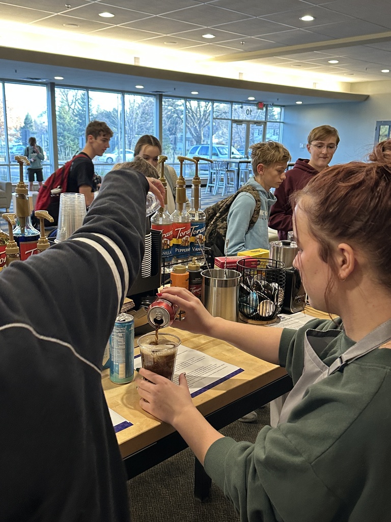 baristas making drinks and students ordering