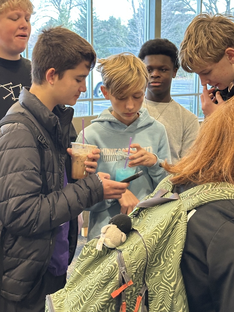 students hanging out a drinking drinks from the coffee cart