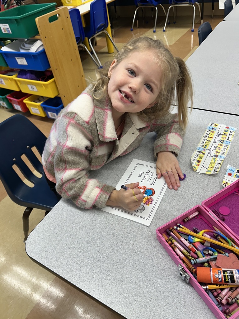 students holding thank you cards for a veteran