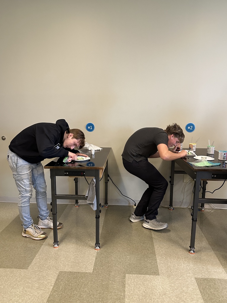students using frosting to decorate a cookie to look like a cell 