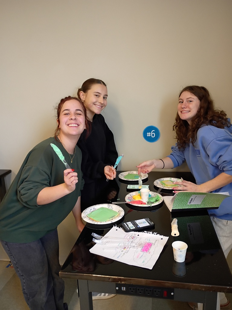 students using frosting to decorate a cookie to look like a cell 