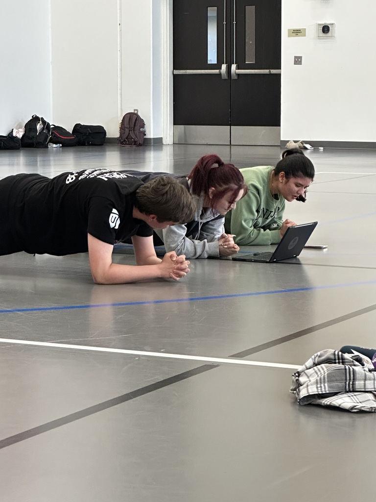 students teaching their peers how to do certain exercises