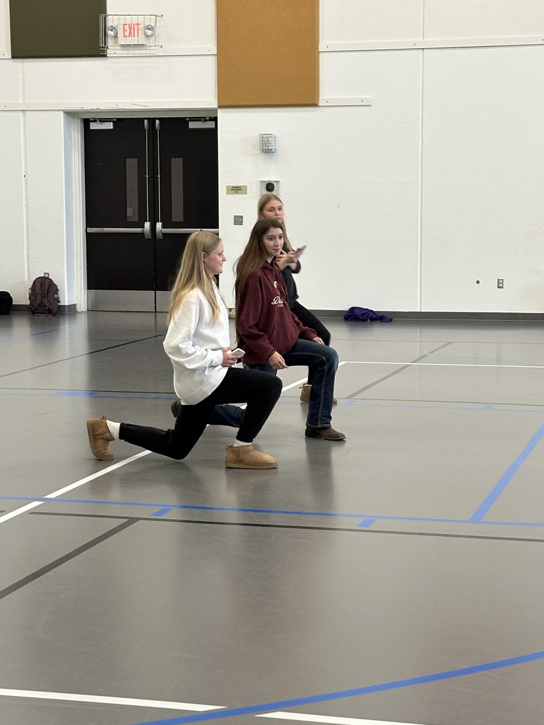 students teaching their peers how to do certain exercises