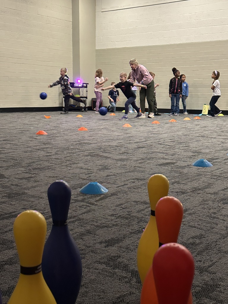 elementary students learning bowling in PE class