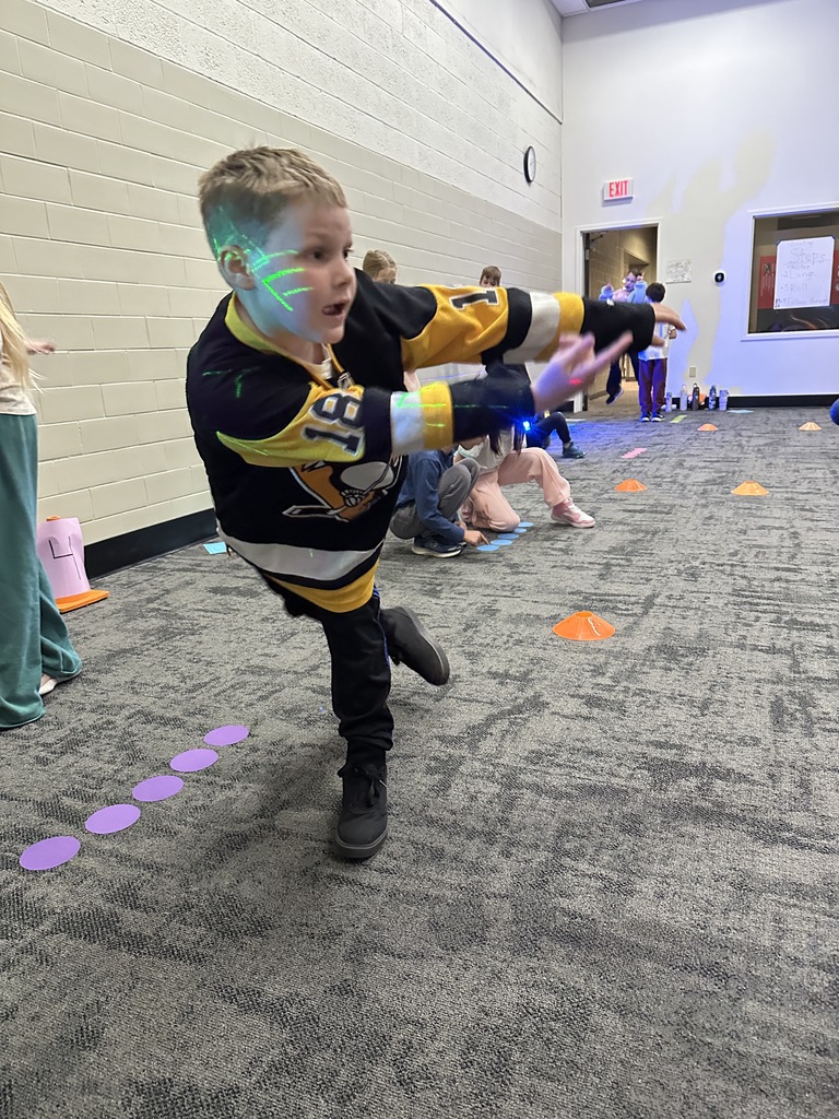 elementary students learning bowling in PE class