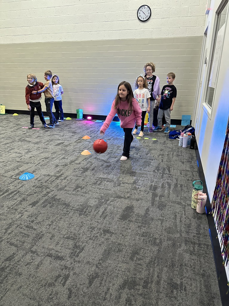 elementary students learning bowling in PE class