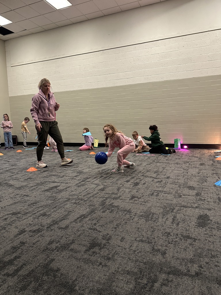 elementary students learning bowling in PE class