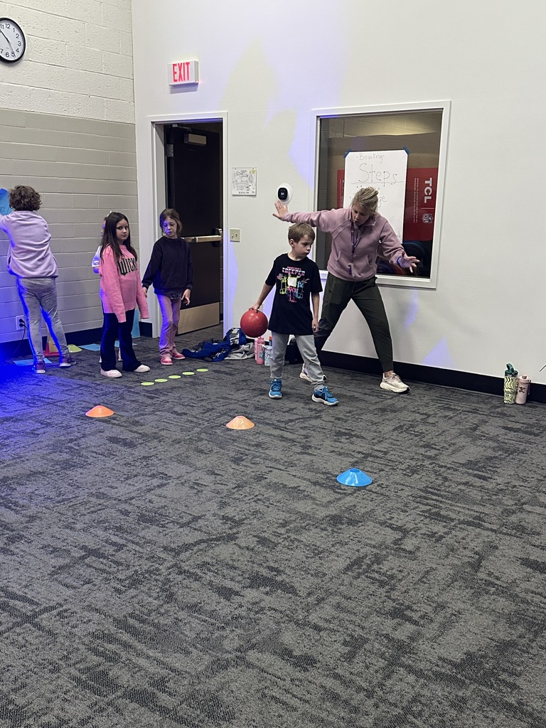 elementary students learning bowling in PE class