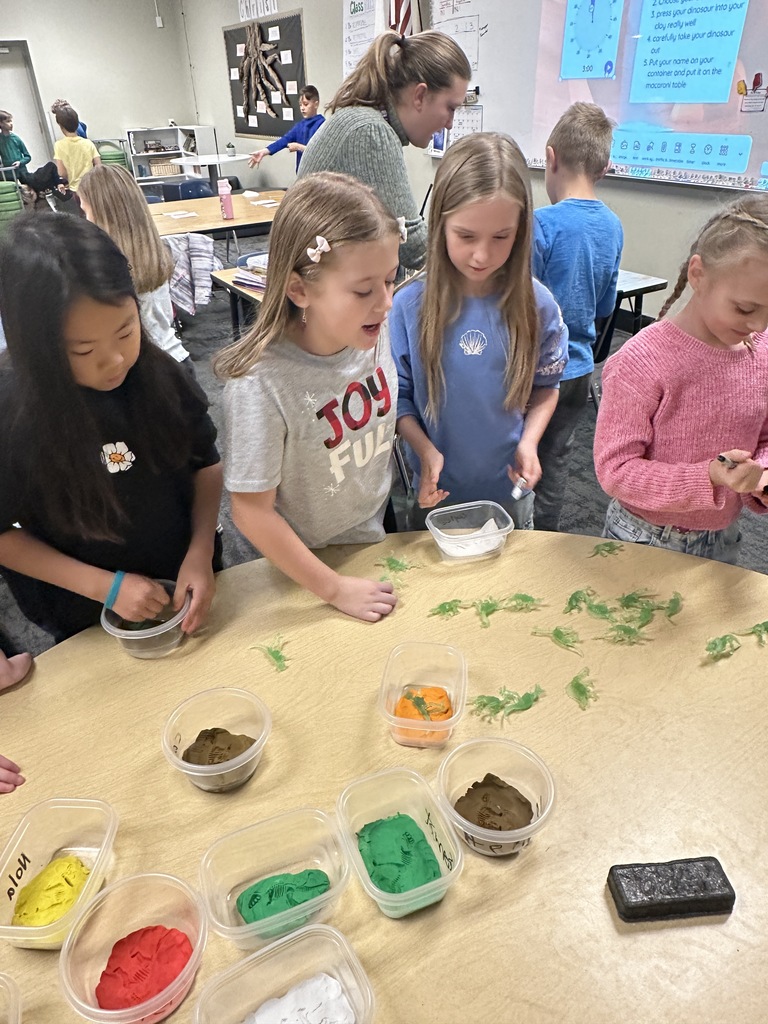 students choosing a dinosaur for a fossil project