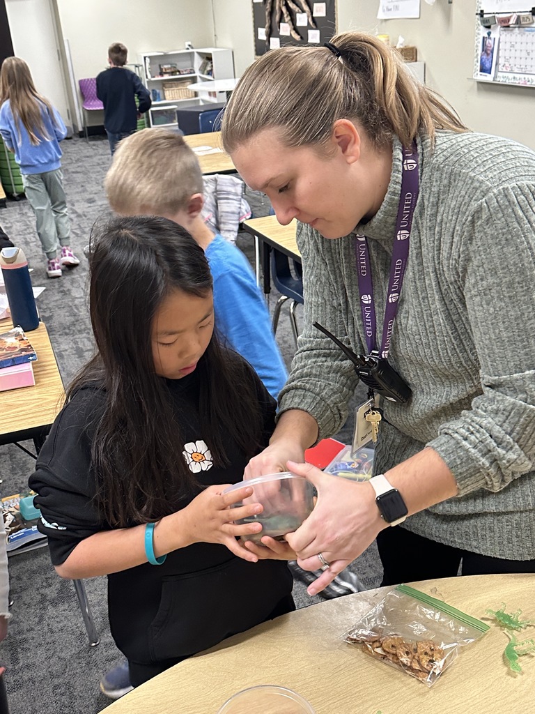 teacher helping student press clay into a container