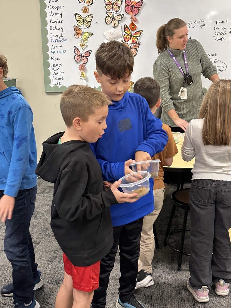 two students showing each other their fossil