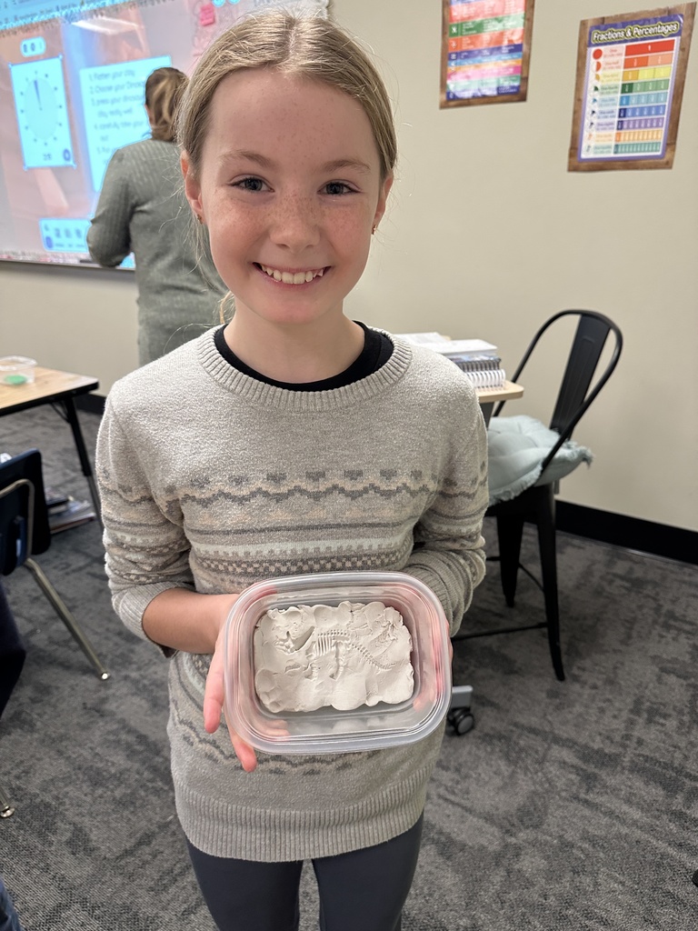 one student showing her dinosaur fossil