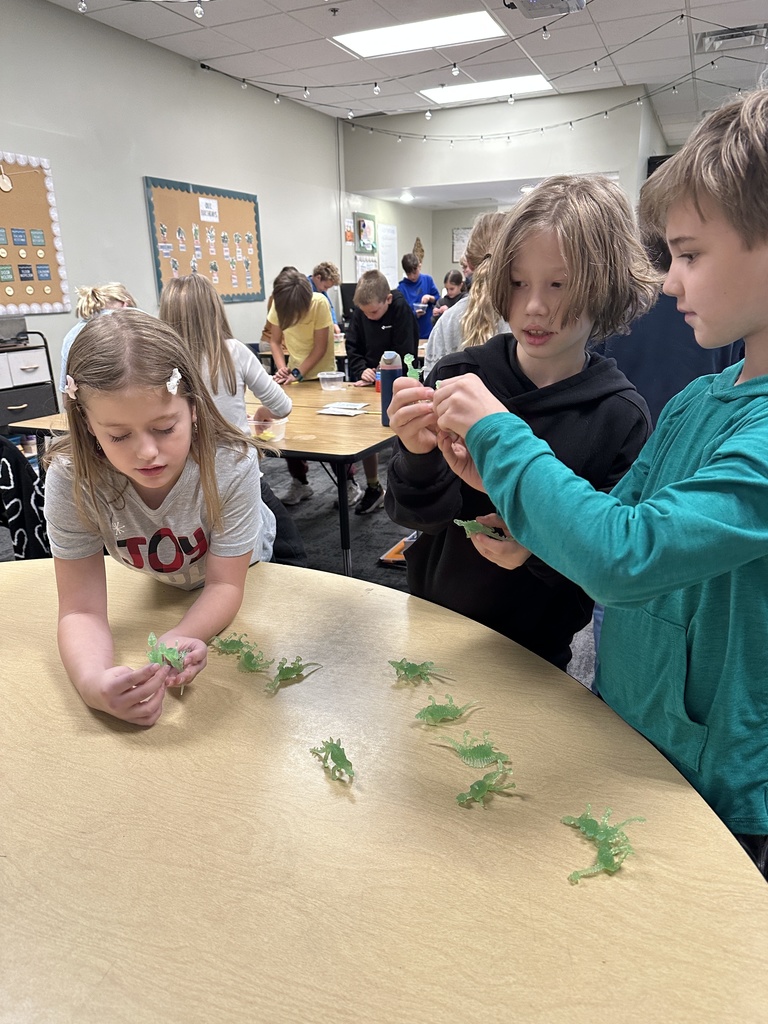 students choosing a dinosaur for a fossil project