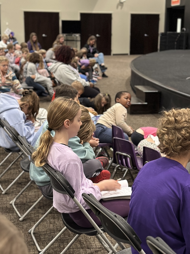 a student reading her bible during a chapel service