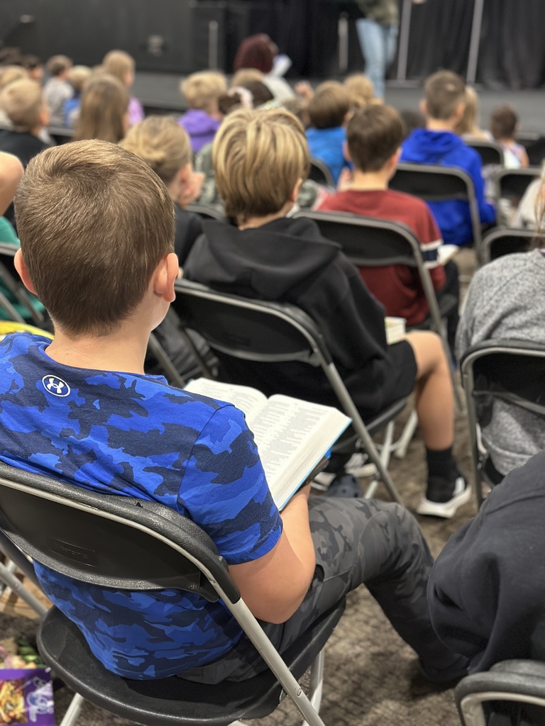 a student reading his bible during a chapel service