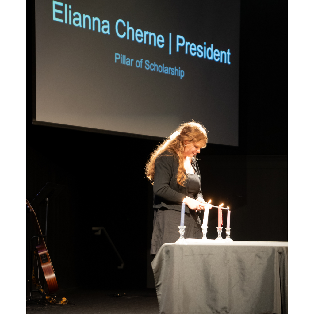 student lighting candles