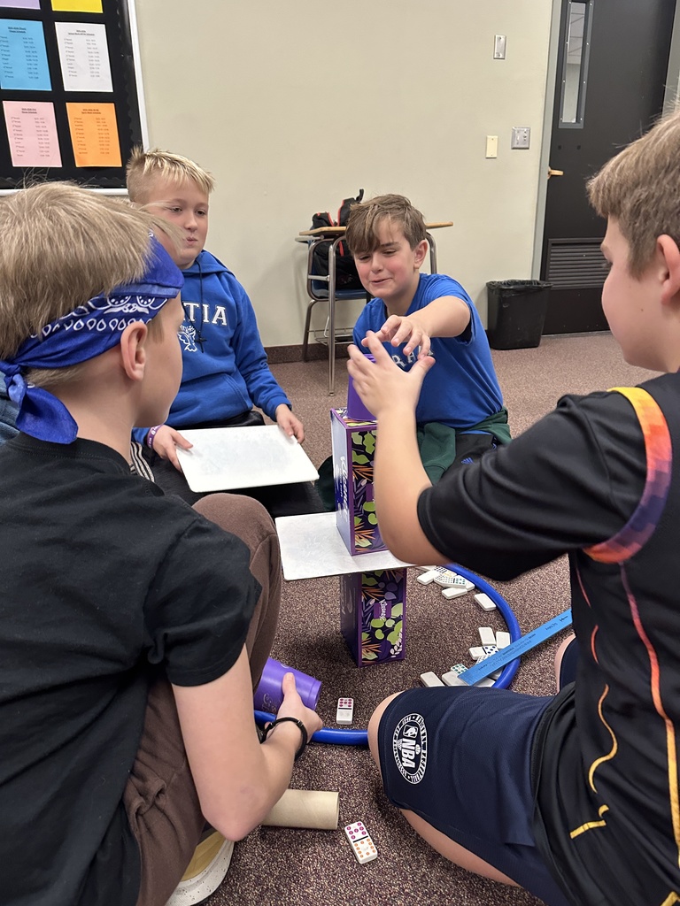 6th grade classmates building towers as a team building exercise