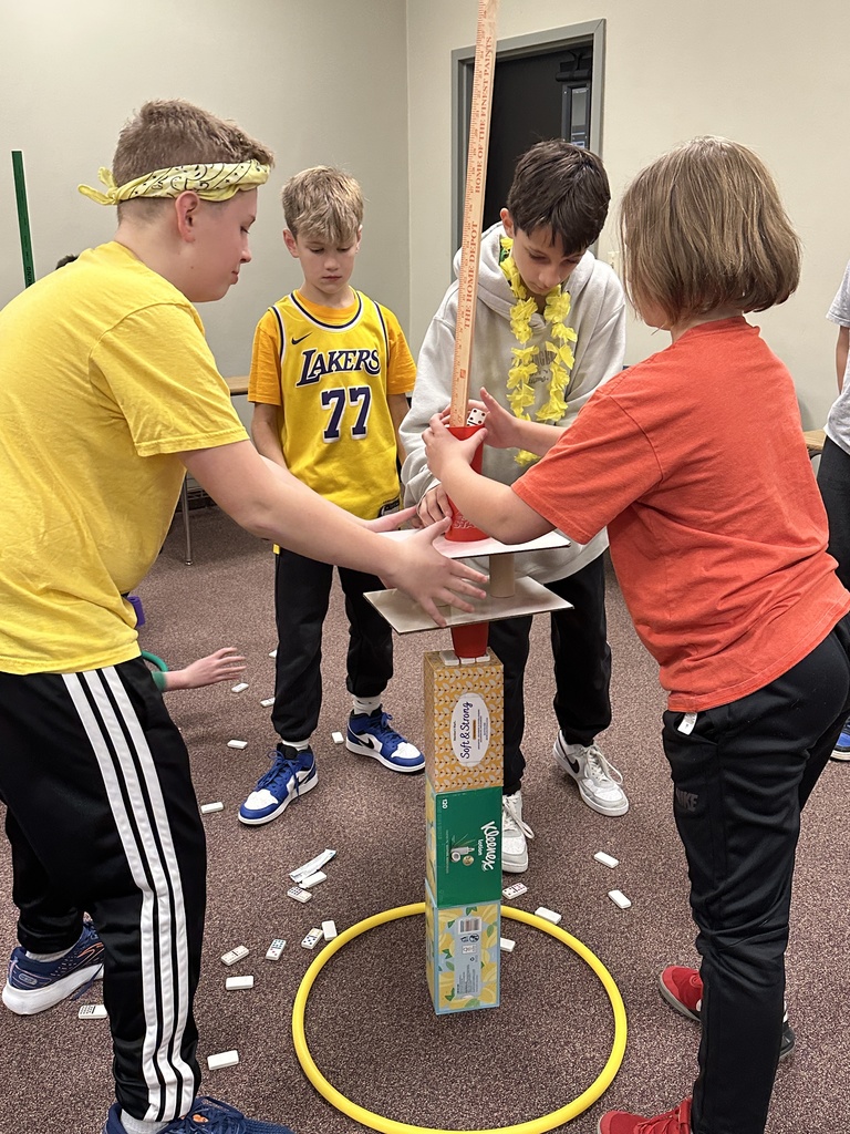 6th grade classmates building towers as a team building exercise