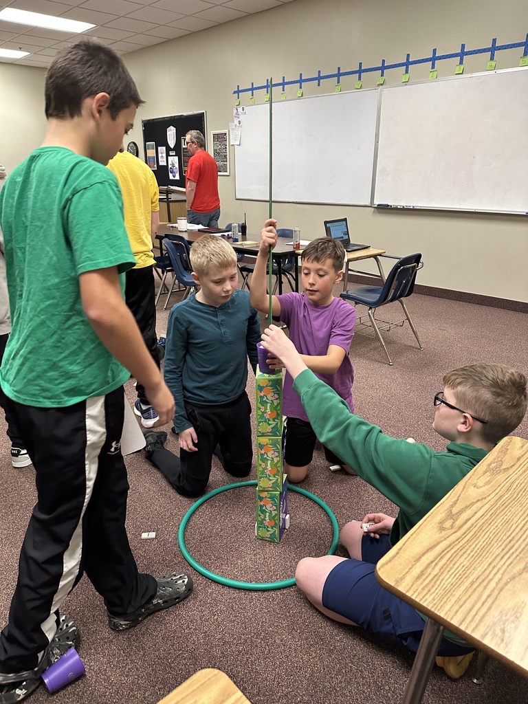 6th grade classmates building towers as a team building exercise