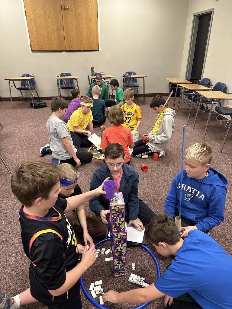 6th grade classmates building towers as a team building exercise