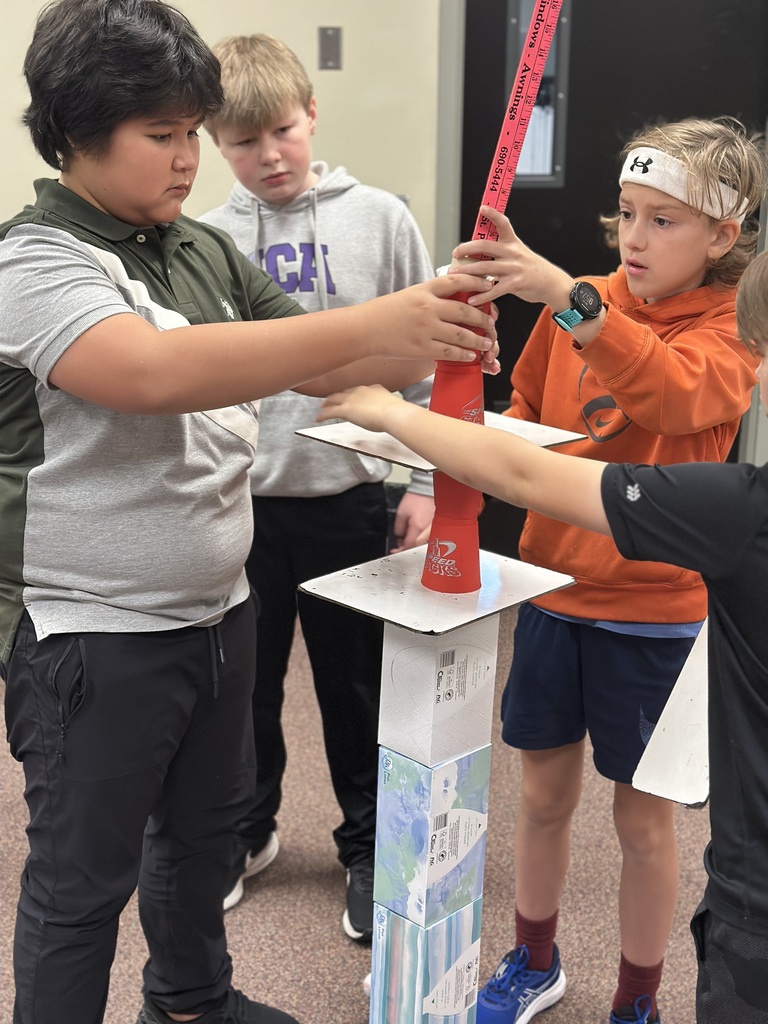 6th grade classmates building towers as a team building exercise