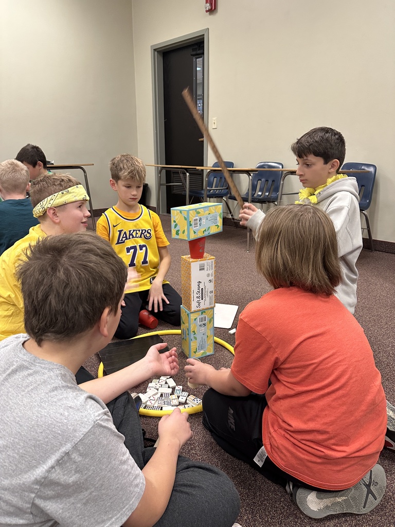 6th grade classmates building towers as a team building exercise