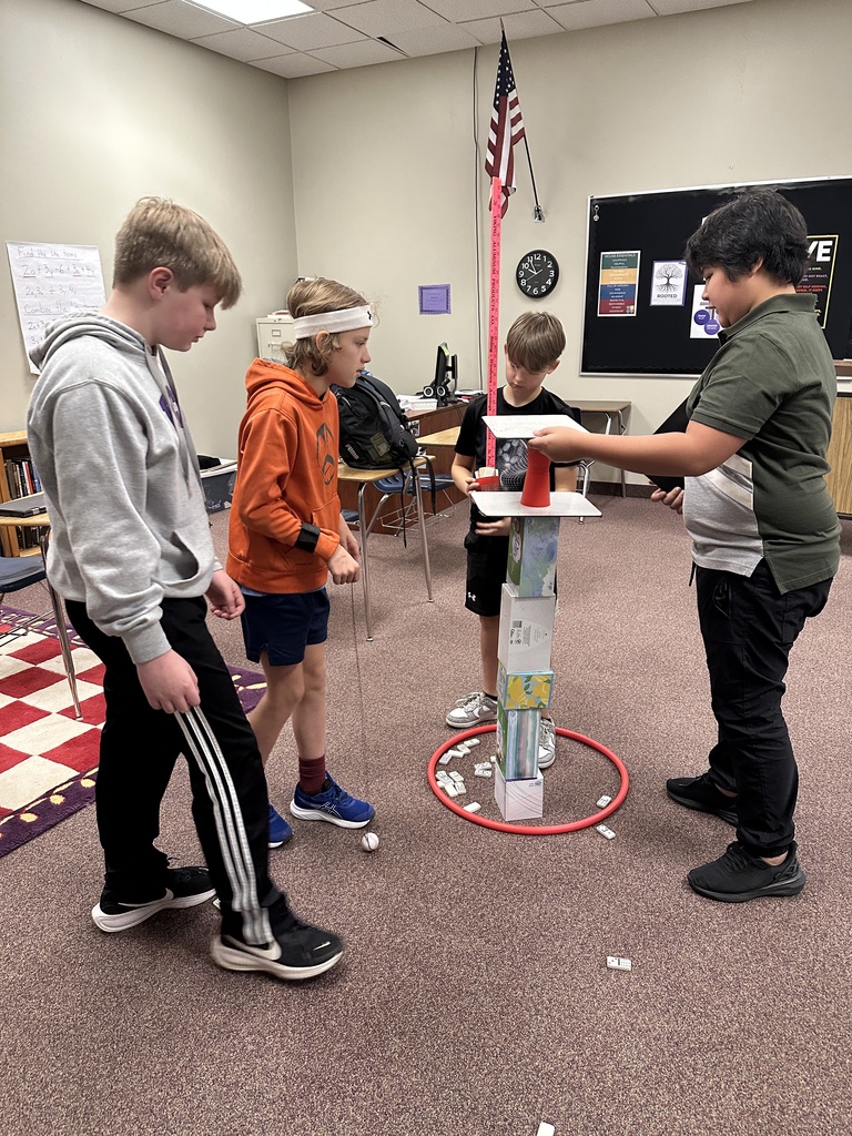 6th grade classmates building towers as a team building exercise