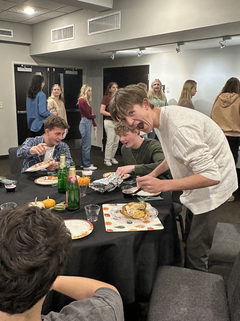 student carving a rotisserie chicken