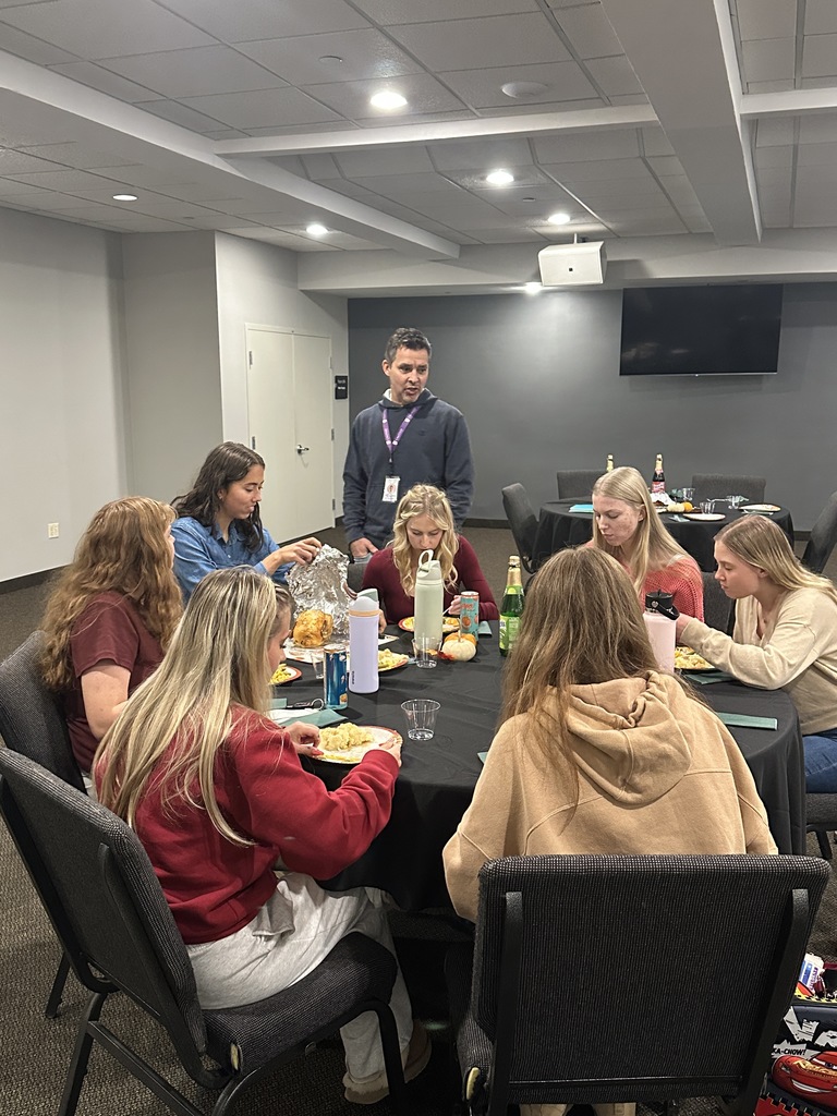 head of school mingling with seniors as they eat lunch