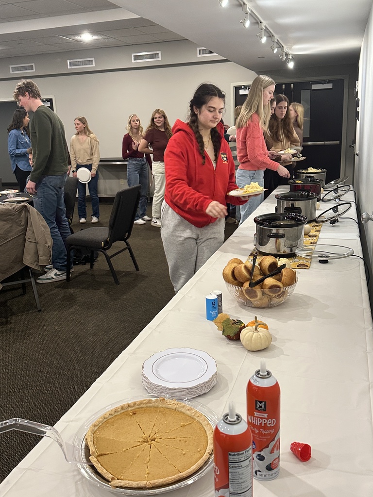 students walking through a buffet line of food