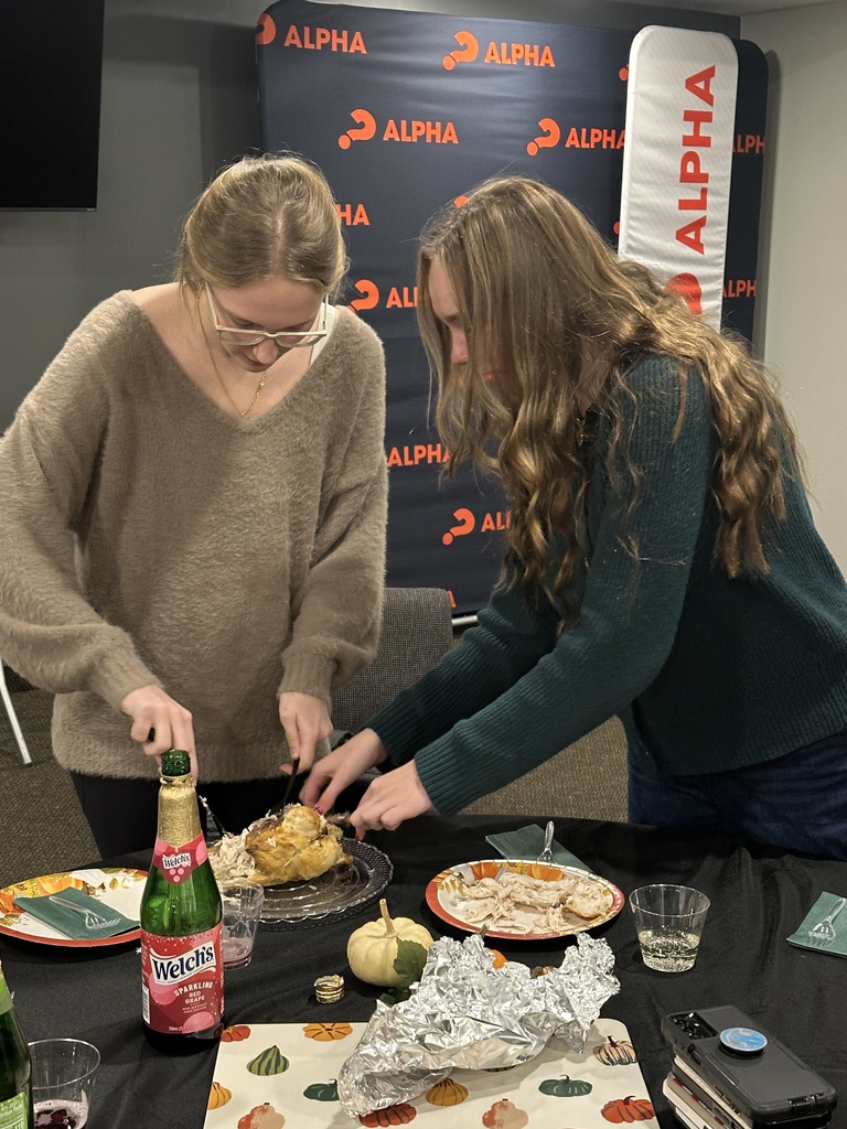 student carving a rotisserie chicken