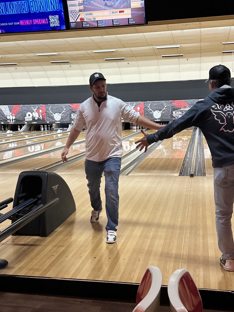 two teachers high-fiving after a bowling turn