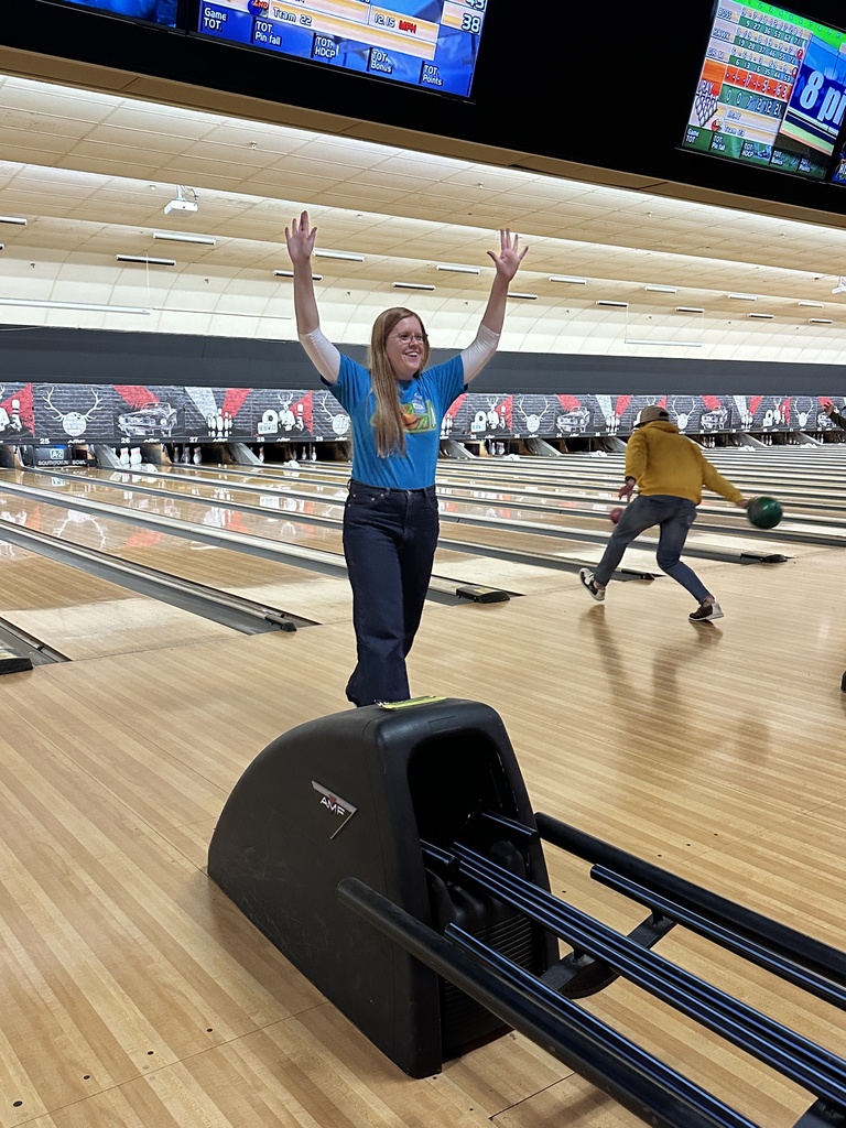 teacher celebrating after bowling a strike