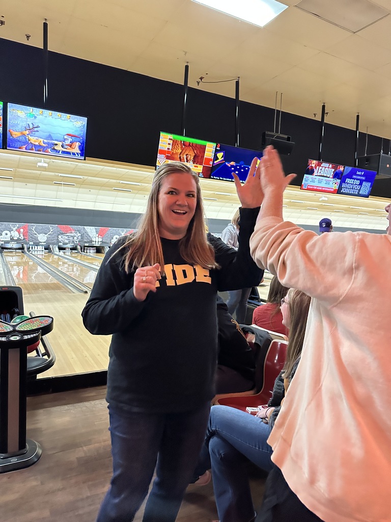 teacher celebrating after bowling a strike