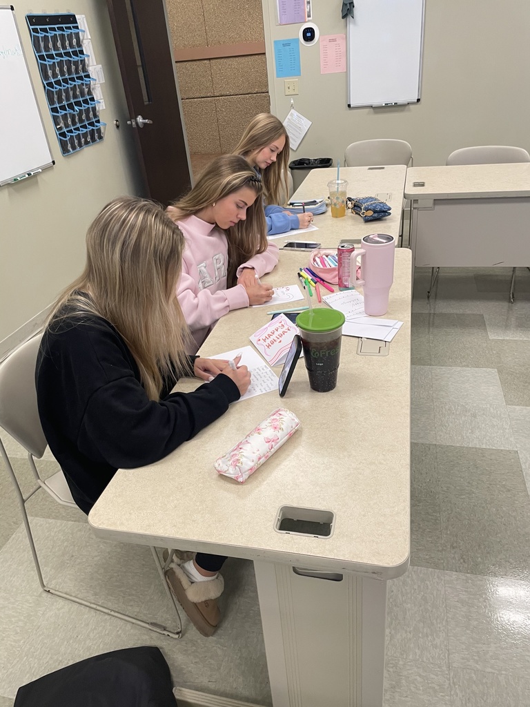 three high school students making cards